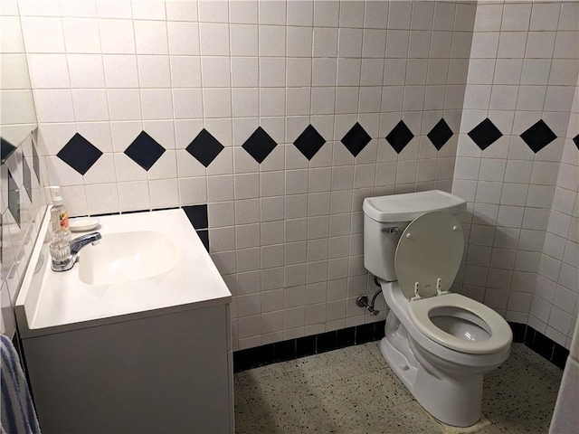 211 Wainwright Dr, Mckeesport, PA 15132 - half bathroom featuring vanity, toilet, and tile walls