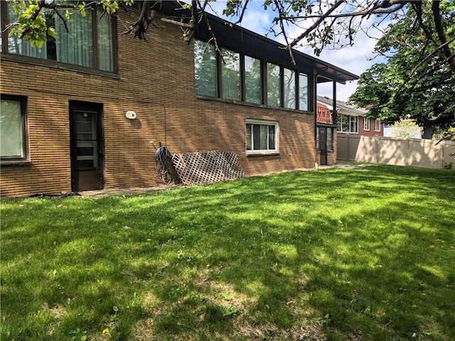211 Wainwright Dr, Mckeesport, PA 15132 - back of house featuring a lawn and brick siding