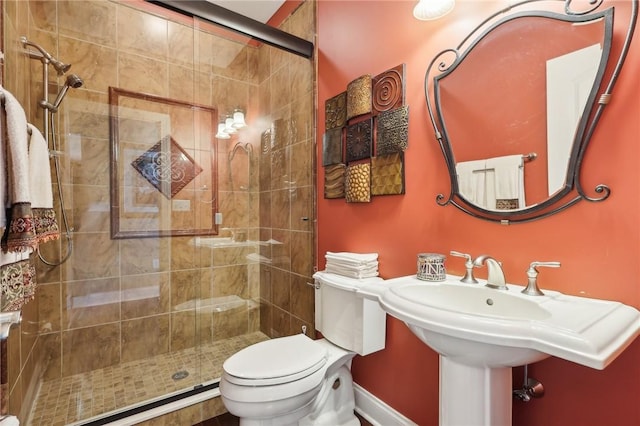 full bath featuring a stall shower and toilet