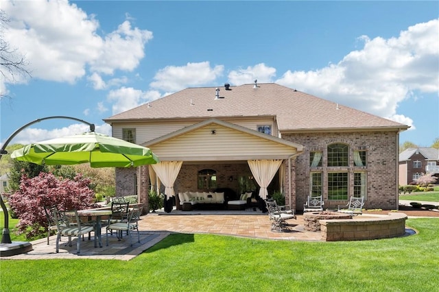 back of house featuring brick siding, a patio, an outdoor living space, and a lawn