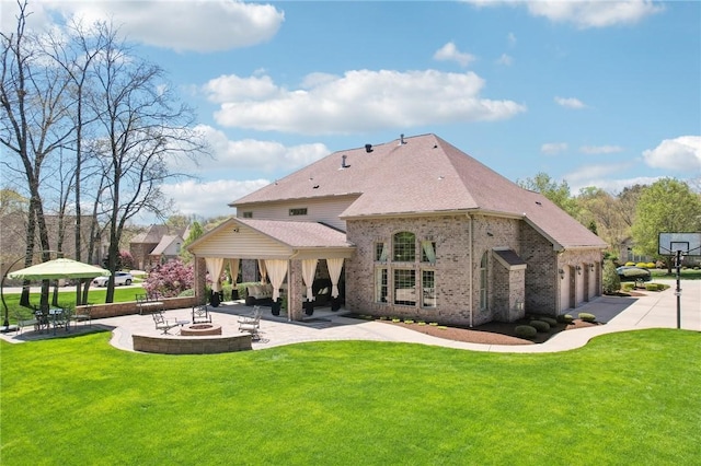 back of house featuring a yard, brick siding, a gazebo, and a patio area