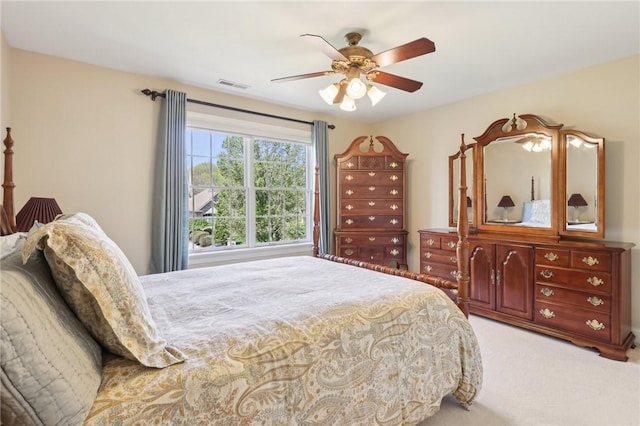 bedroom with ceiling fan, visible vents, and light carpet