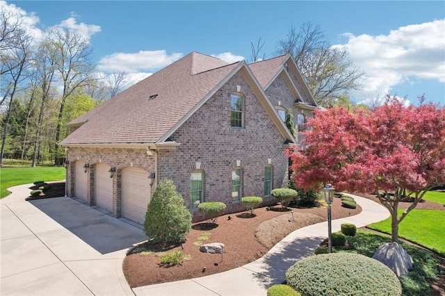 view of property exterior with concrete driveway, brick siding, a lawn, and roof with shingles
