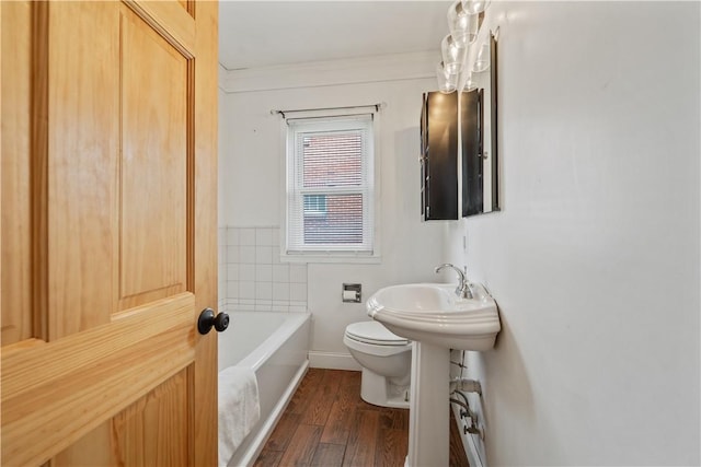 bathroom featuring toilet, a bathtub, and wood finished floors