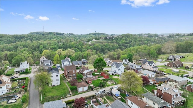 drone / aerial view with a residential view and a forest view