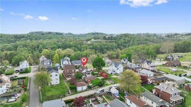 birds eye view of property featuring a wooded view and a residential view