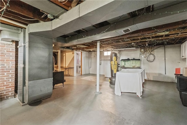 basement featuring visible vents and heating unit