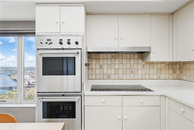 111 Grandview Ave Unit 801, Mt Washington, PA 15211 - kitchen with multiple ovens, black electric stovetop, a healthy amount of sunlight, and tasteful backsplash
