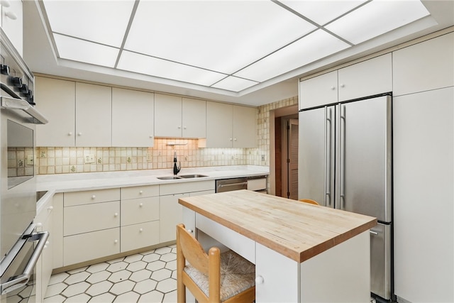 111 Grandview Ave Unit 801, Mt Washington, PA 15211 - kitchen featuring light floors, a sink, wood counters, and stainless steel appliances