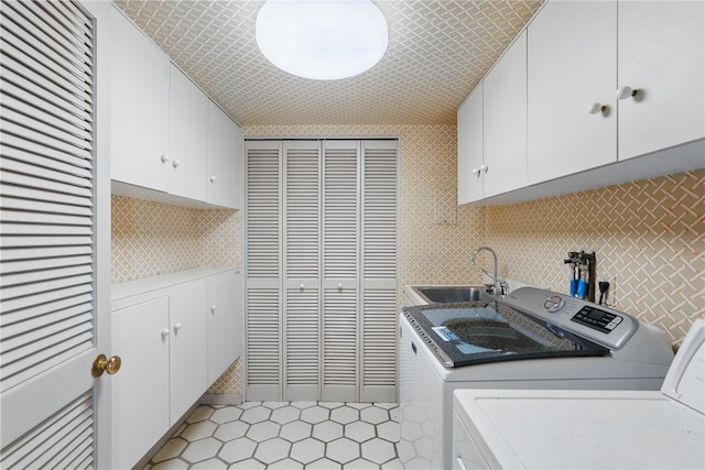 111 Grandview Ave Unit 801, Mt Washington, PA 15211 - clothes washing area featuring washing machine and dryer, tile walls, a sink, cabinet space, and light tile patterned floors