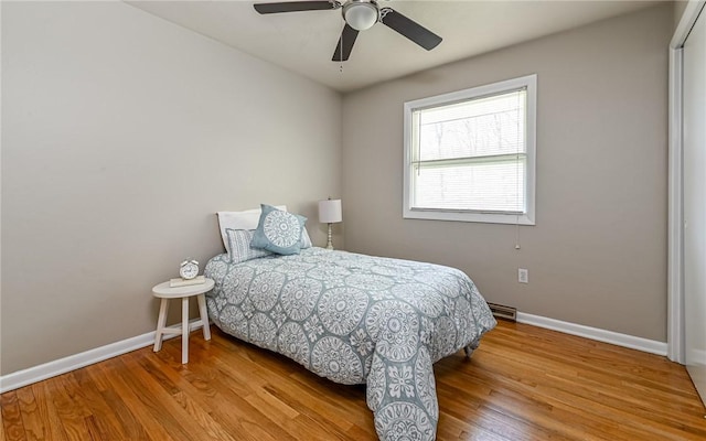bedroom featuring baseboards, a ceiling fan, and wood finished floors