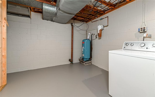 washroom with washer / clothes dryer, concrete block wall, laundry area, and water heater