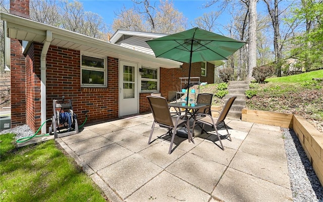 view of patio with cooling unit and outdoor dining space