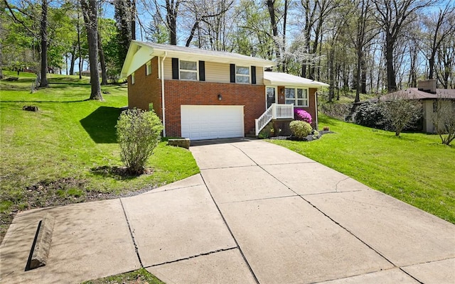 tri-level home featuring brick siding, a garage, a front lawn, and concrete driveway