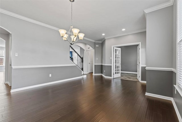 interior space with arched walkways, a chandelier, recessed lighting, baseboards, and wood finished floors