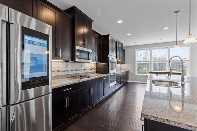 238 Gabriel Dr, Adams Twp, PA 16046 - kitchen featuring appliances with stainless steel finishes, a sink, light stone countertops, baseboards, and backsplash