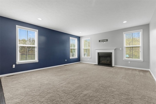 238 Gabriel Dr, Adams Twp, PA 16046 - unfurnished living room featuring a fireplace with flush hearth, carpet floors, baseboards, and recessed lighting