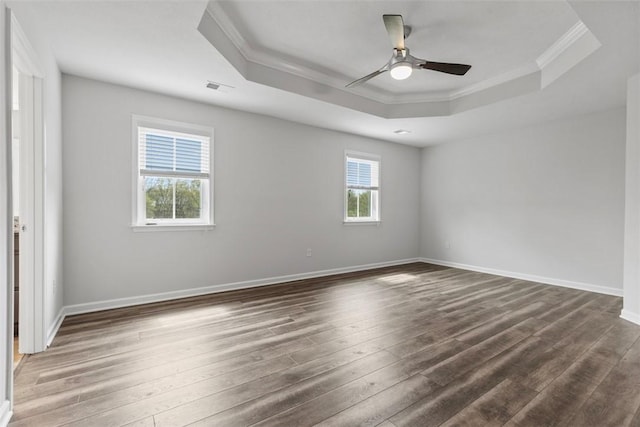 unfurnished room featuring ornamental molding, a raised ceiling, ceiling fan, and hardwood / wood-style floors