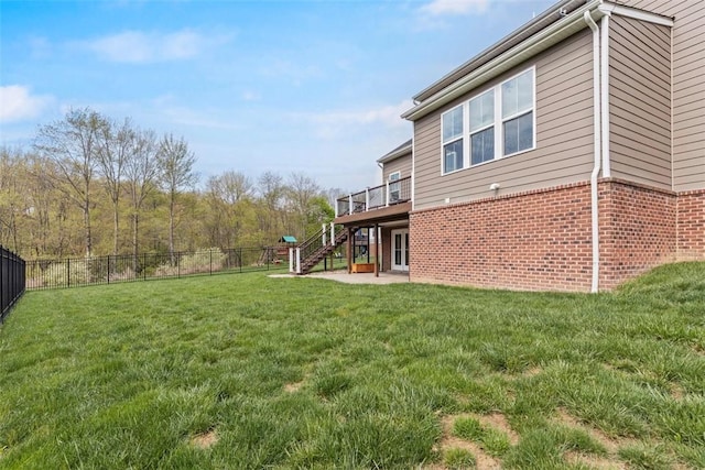view of yard with a patio area, fence, stairway, and a deck