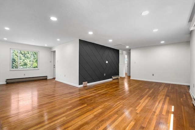 2410 Nicholson Rd, Franklin Park, PA 15143 - unfurnished living room featuring a baseboard heating unit, baseboards, and wood finished floors