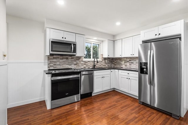2410 Nicholson Rd, Franklin Park, PA 15143 - kitchen featuring stainless steel appliances, dark countertops, dark wood finished floors, and a sink