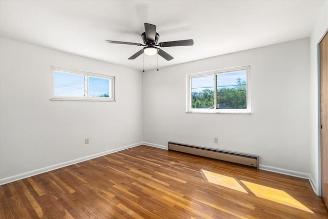 2410 Nicholson Rd, Franklin Park, PA 15143 - unfurnished room with wood finished floors, baseboards, a baseboard heating unit, and a wealth of natural light