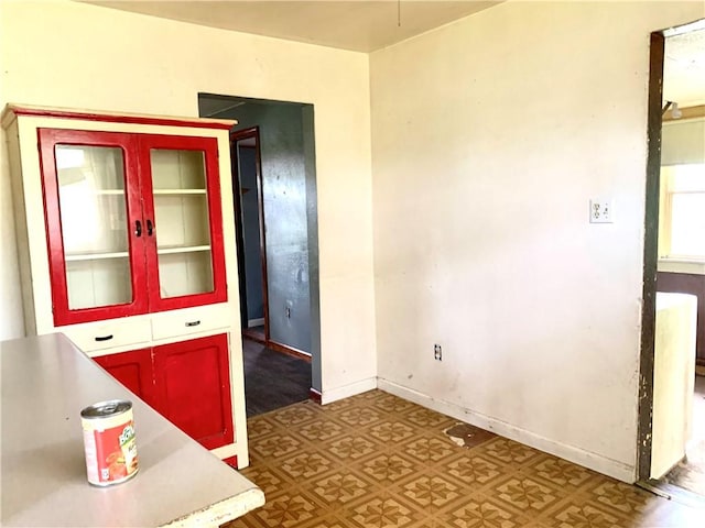 spare room featuring baseboards and tile patterned floors