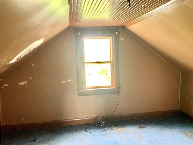 bonus room featuring baseboards and vaulted ceiling