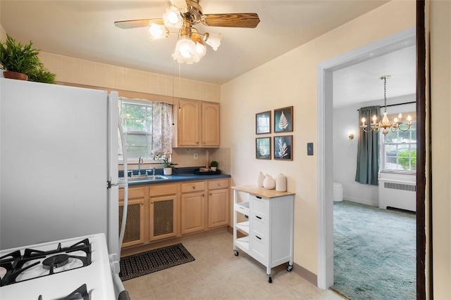 4044 Cloverlea St, Brentwood, PA 15227 - kitchen with light brown cabinetry, a sink, white appliances, radiator heating unit, and ceiling fan with notable chandelier