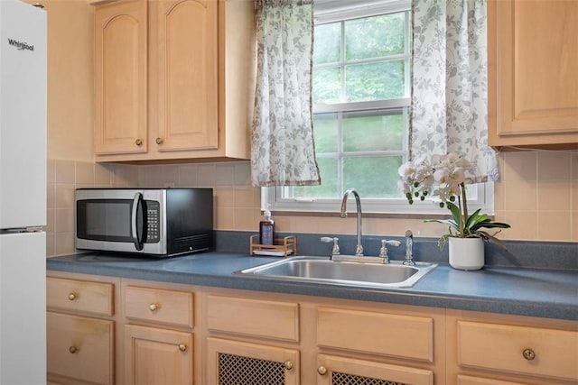 4044 Cloverlea St, Brentwood, PA 15227 - kitchen with stainless steel microwave, a sink, and light brown cabinets