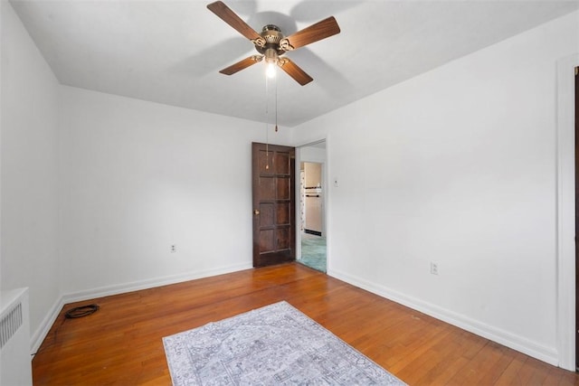 4044 Cloverlea St, Brentwood, PA 15227 - empty room featuring baseboards, ceiling fan, wood finished floors, and radiator