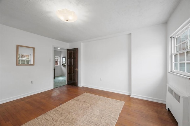 4044 Cloverlea St, Brentwood, PA 15227 - spare room featuring wood finished floors, baseboards, and radiator heating unit