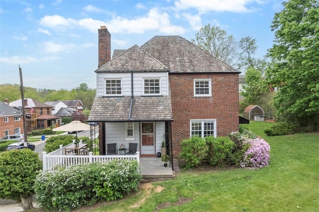 4044 Cloverlea St, Brentwood, PA 15227 - view of front of property featuring brick siding, a front yard, a high end roof, and a chimney
