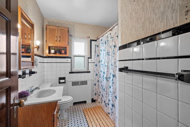 4044 Cloverlea St, Brentwood, PA 15227 - bathroom with tile walls, wainscoting, toilet, radiator heating unit, and wallpapered walls