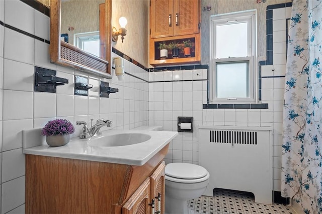 4044 Cloverlea St, Brentwood, PA 15227 - bathroom with radiator, a healthy amount of sunlight, and tile walls