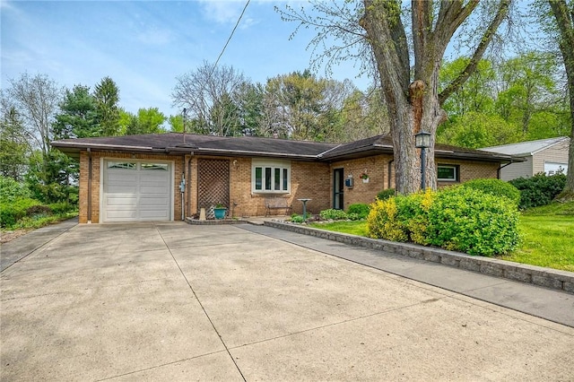 ranch-style home featuring brick siding, an attached garage, and concrete driveway