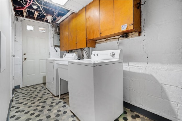 laundry room featuring cabinet space, light floors, electric panel, and washer and dryer