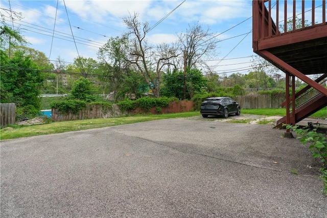 view of car parking featuring fence