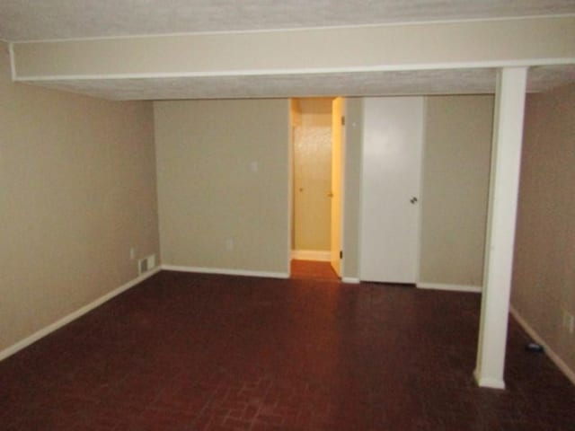 finished basement with baseboards and visible vents