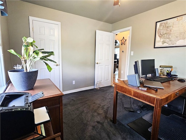 office with a ceiling fan, baseboards, and dark colored carpet