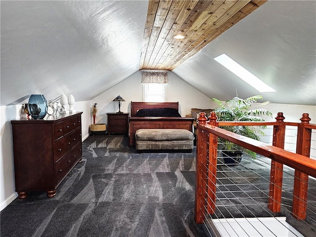 carpeted bedroom featuring vaulted ceiling with skylight and baseboards