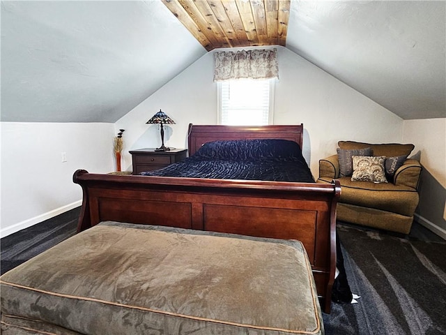 carpeted bedroom featuring baseboards and vaulted ceiling
