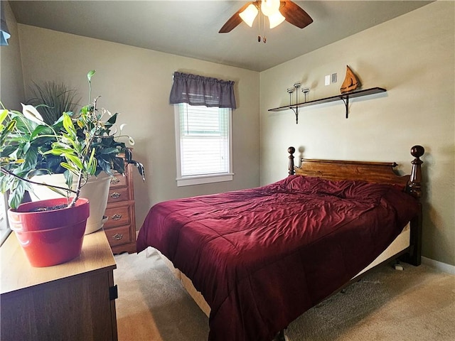 carpeted bedroom featuring baseboards and a ceiling fan