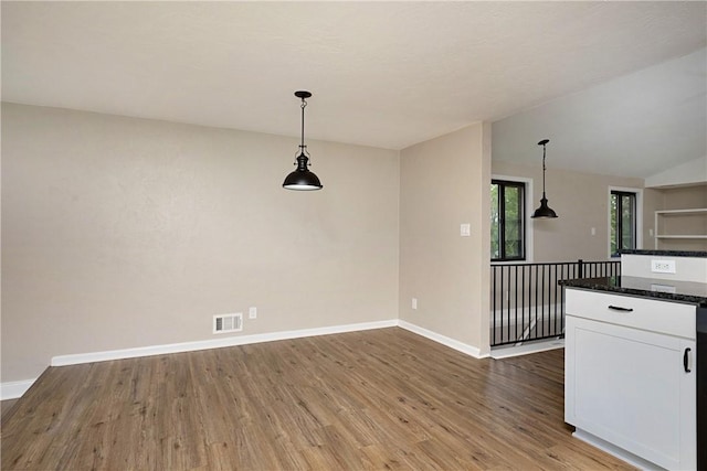 4917 Leona Dr, Baldwin Boro, PA 15227 - kitchen with baseboards, wood finished floors, white cabinets, and decorative light fixtures