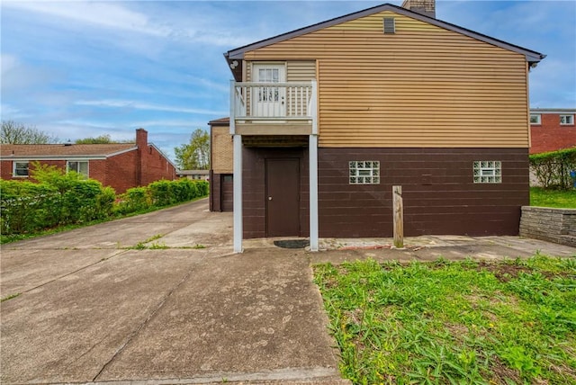 4917 Leona Dr, Baldwin Boro, PA 15227 - view of home's exterior featuring a chimney, a balcony, and a garage
