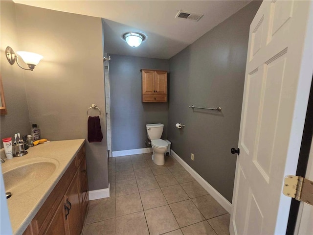 bathroom featuring visible vents, vanity, toilet, baseboards, and tile patterned floors
