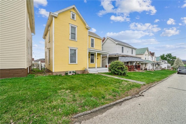 view of front of property with a porch, a residential view, and a front yard