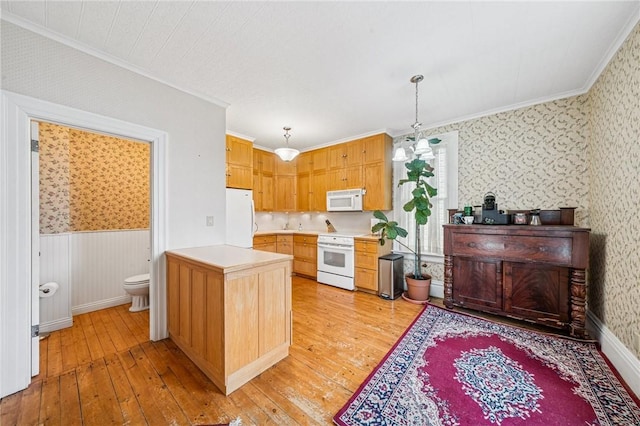 kitchen featuring white appliances, wallpapered walls, and crown molding