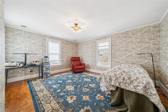bedroom featuring crown molding, baseboards, and hardwood / wood-style floors