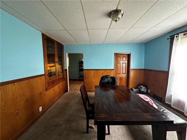 606 Chestnut St, New Castle/3Rd, PA 16101 - carpeted dining space featuring wainscoting, wooden walls, and a drop ceiling